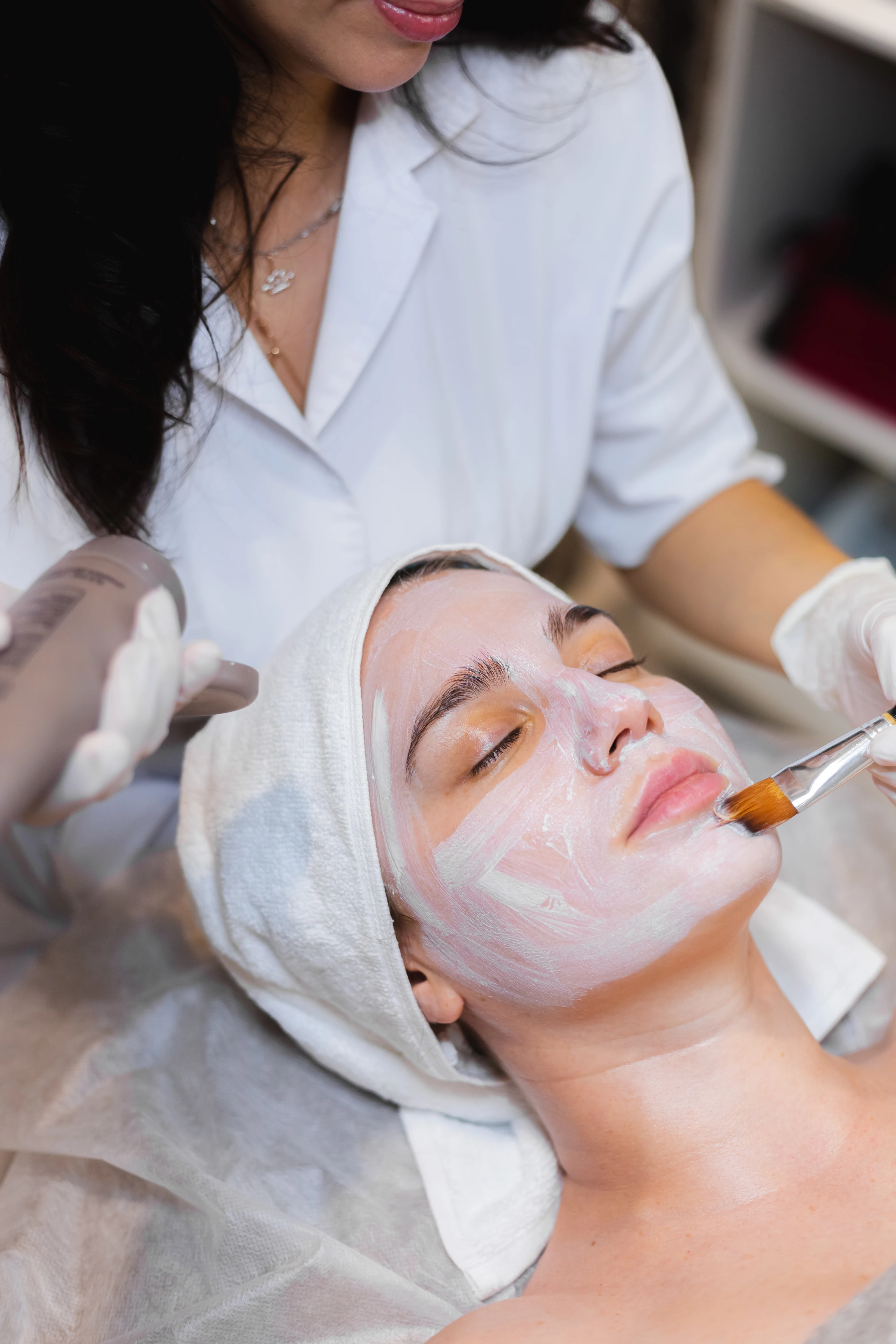 Woman receiving a relaxing organic facial treatment in Manhattan.