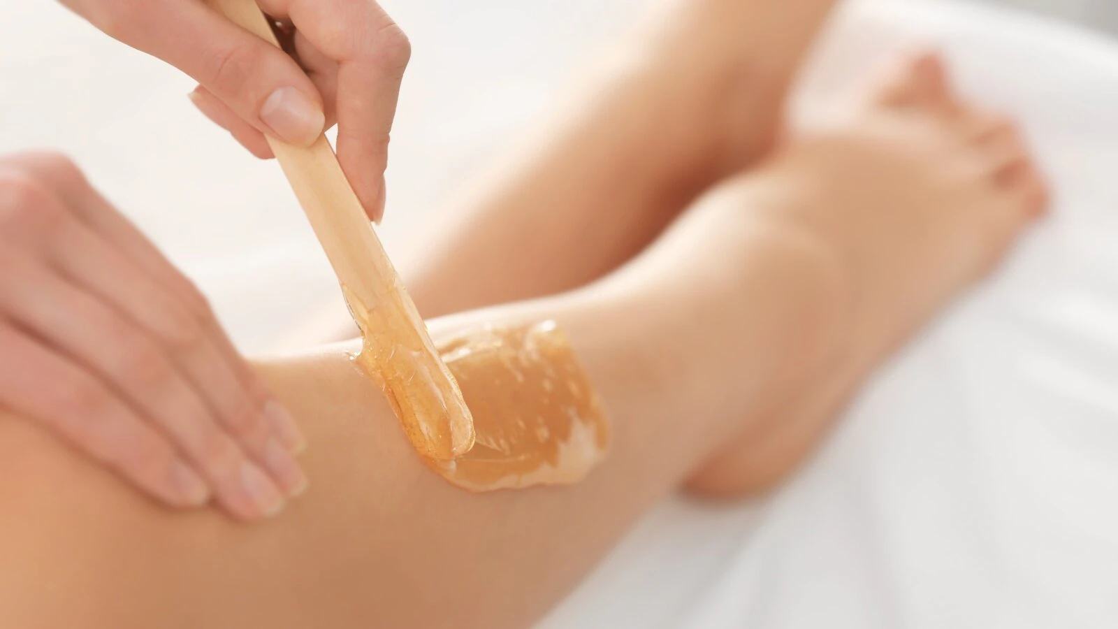 Leg Sugaring Treatment Professional leg sugaring hair removal treatment applying sugar paste