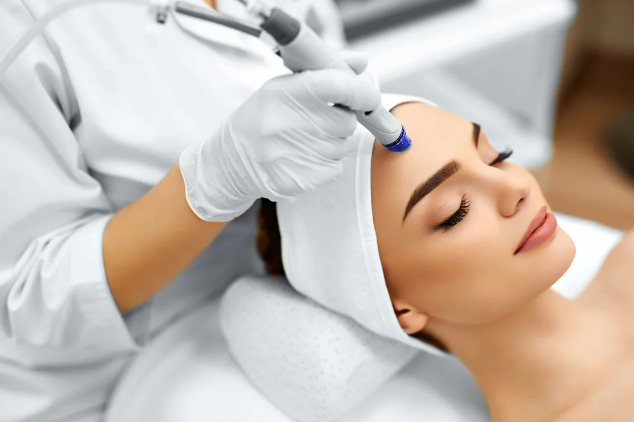 Microdermabrasion treatment at NYBrow, showcasing a professional aesthetician using a diamond-tipped wand on a client's face