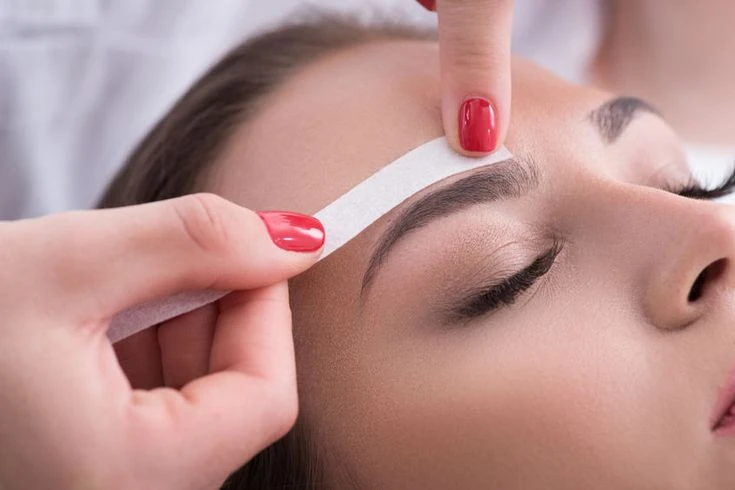 Wax strip application and removal process for precise eyebrow shaping