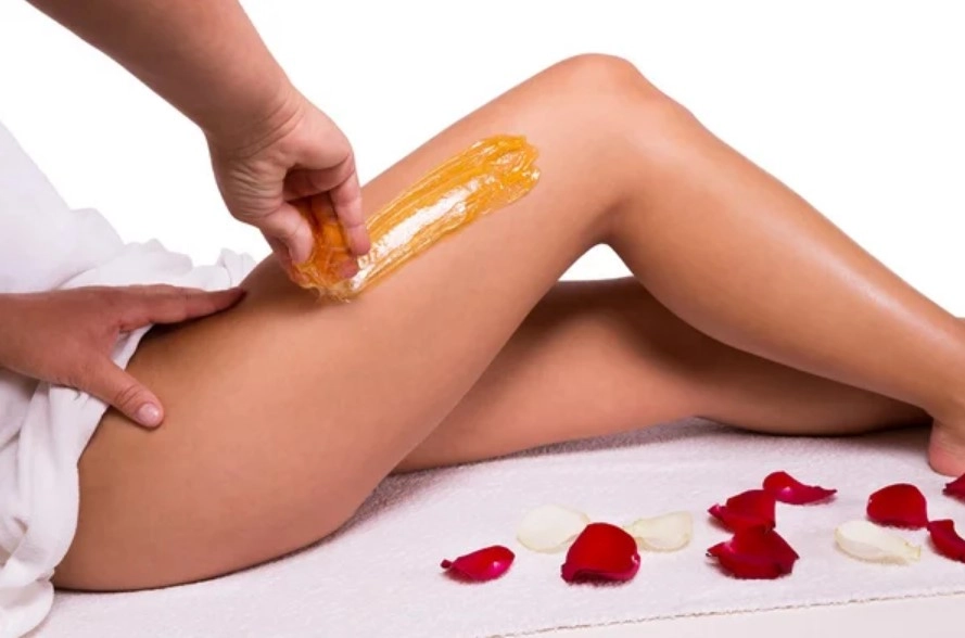 Leg waxing paste application for smooth skin