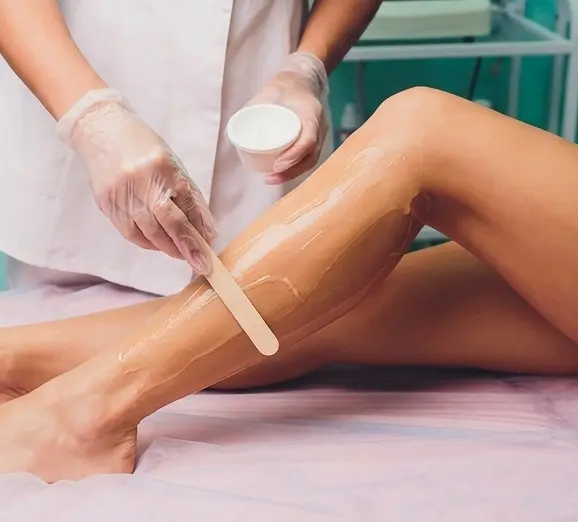 Clients reviewing full body waxing treatments and package prices before booking