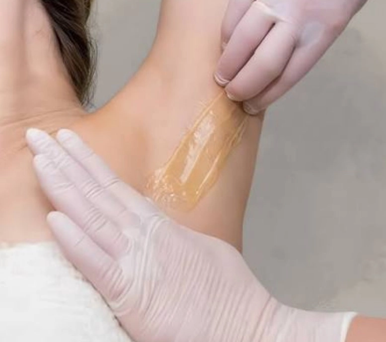 Underarm sugaring paste application in NYC salon